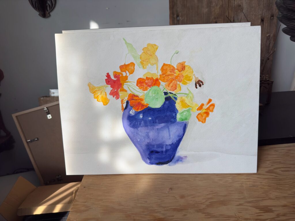 A watercolor painting on paper. The rendering shows orange and yellow nasturtiums in a cobalt blue vase